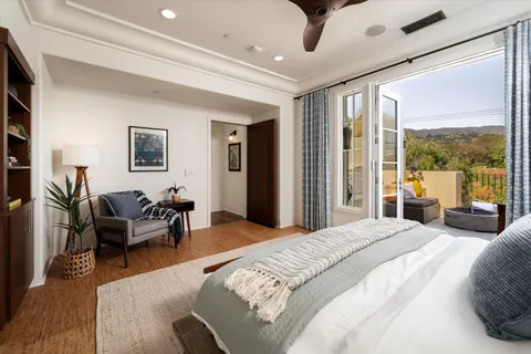 a bedroom with a large bed and a large window