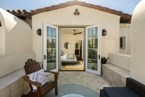 a spacious bedroom with a bed and glass door