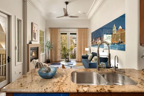 a kitchen with sink granite counter top space and living room