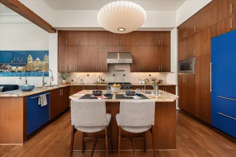 a kitchen with a sink a counter space and stainless steel appliances