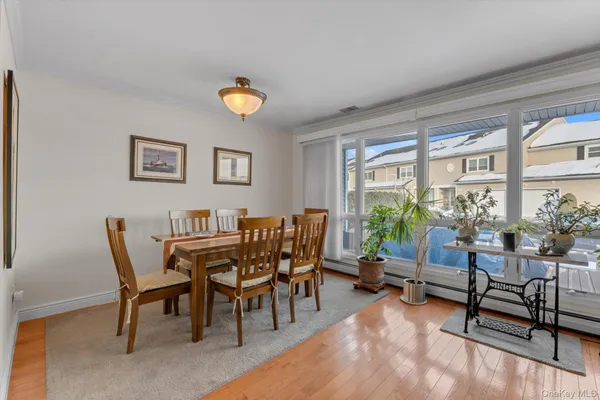 a dining room with furniture a rug and a large window