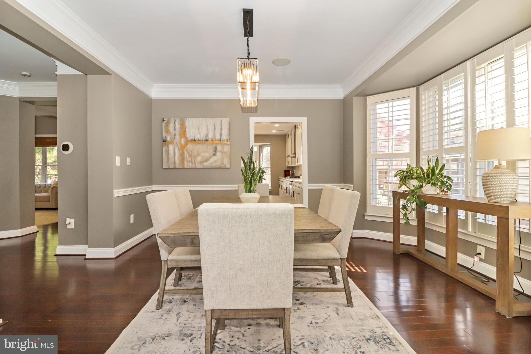 22773 Highcrest Circle Brambleton, VA 20148 - Photo 13 of 40 a dining room with furniture a chandelier and wooden floor