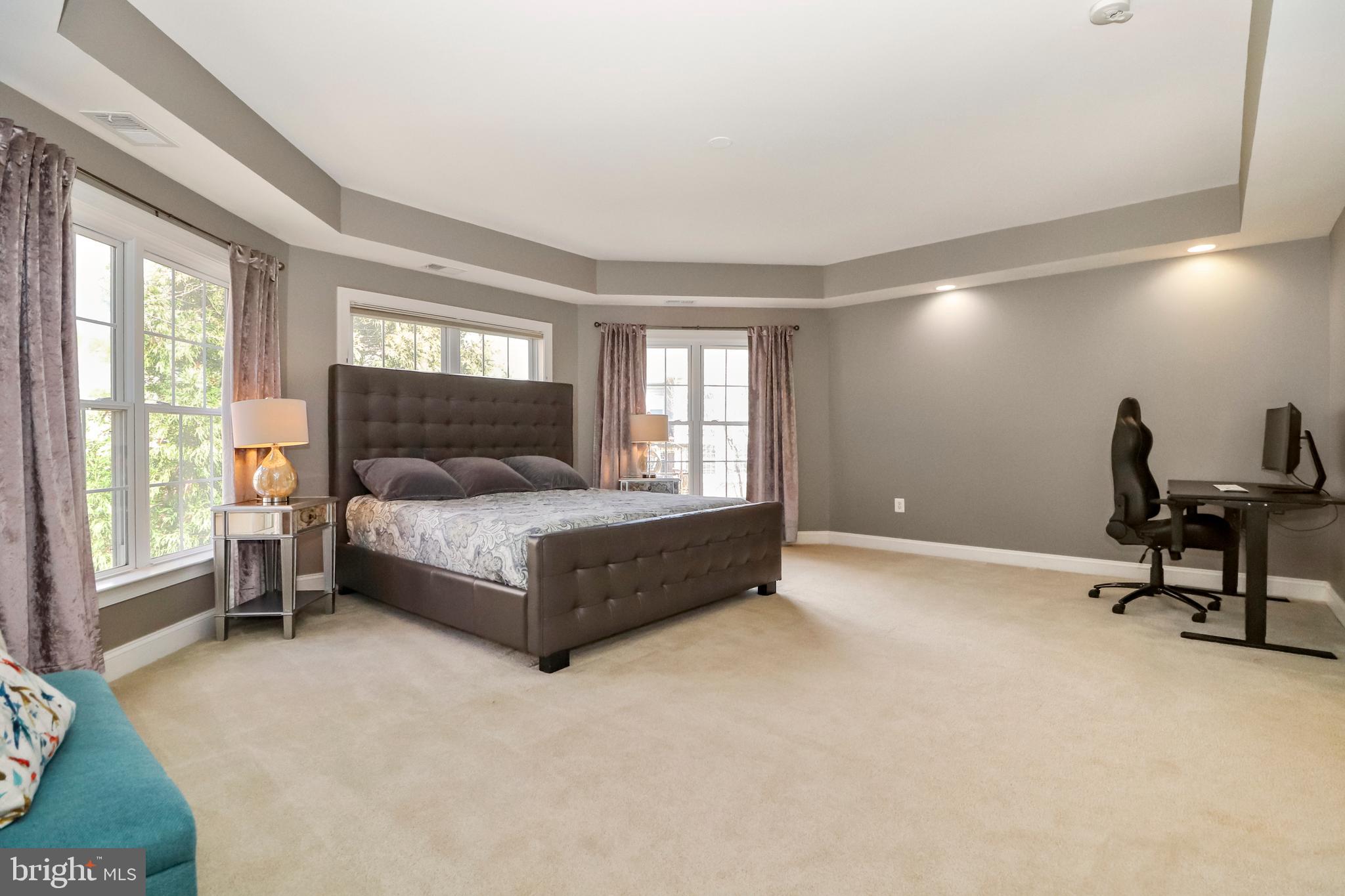 22773 Highcrest Circle Brambleton, VA 20148 - Photo 19 of 40 a bedroom with a bed a table and windows