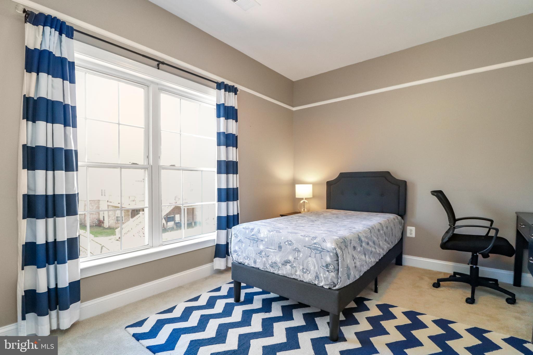 22773 Highcrest Circle Brambleton, VA 20148 - Photo 22 of 40 a bedroom with a bed and a large window