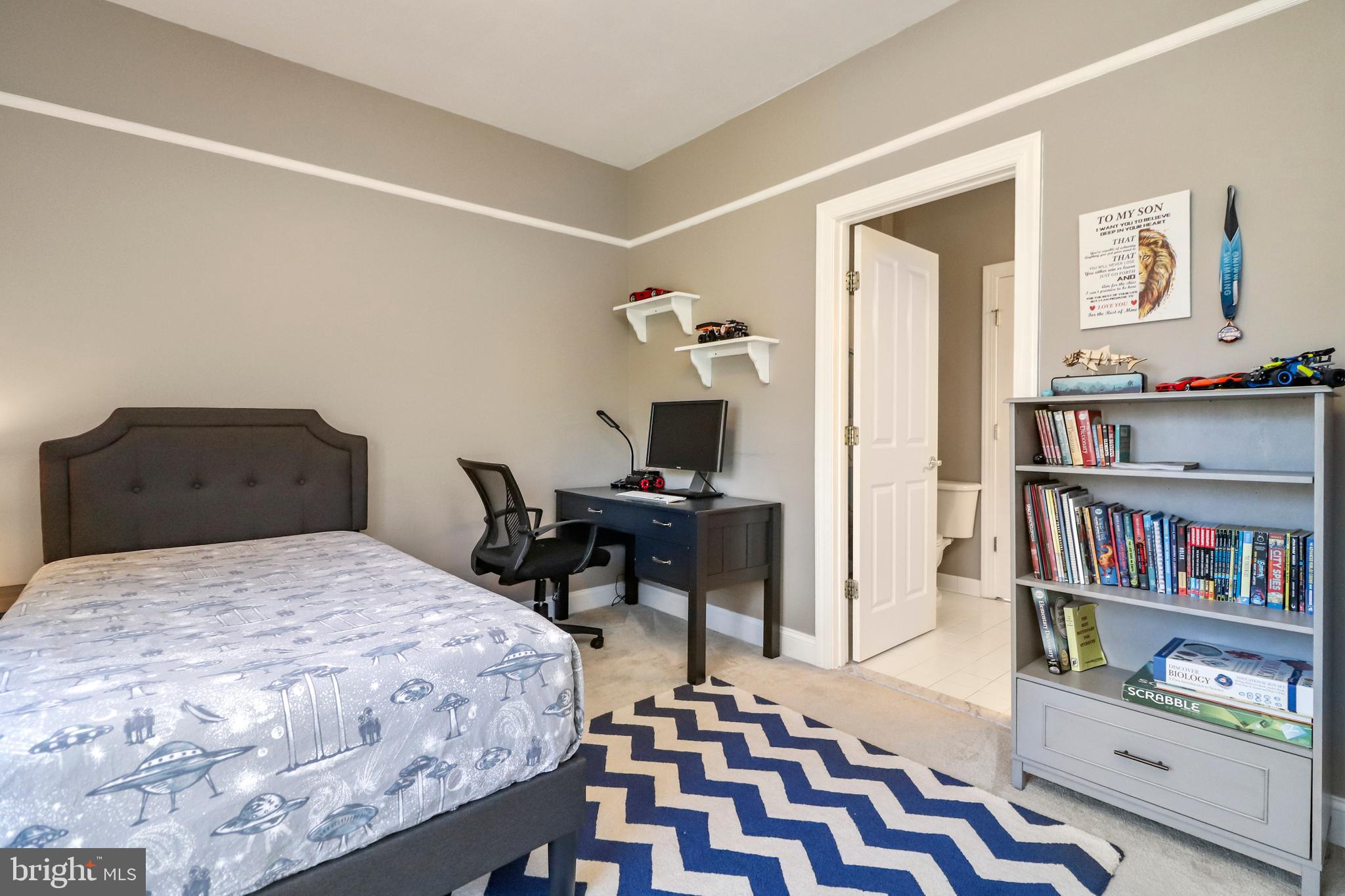 22773 Highcrest Circle Brambleton, VA 20148 - Photo 23 of 40 a bedroom with a bed and a book shelf