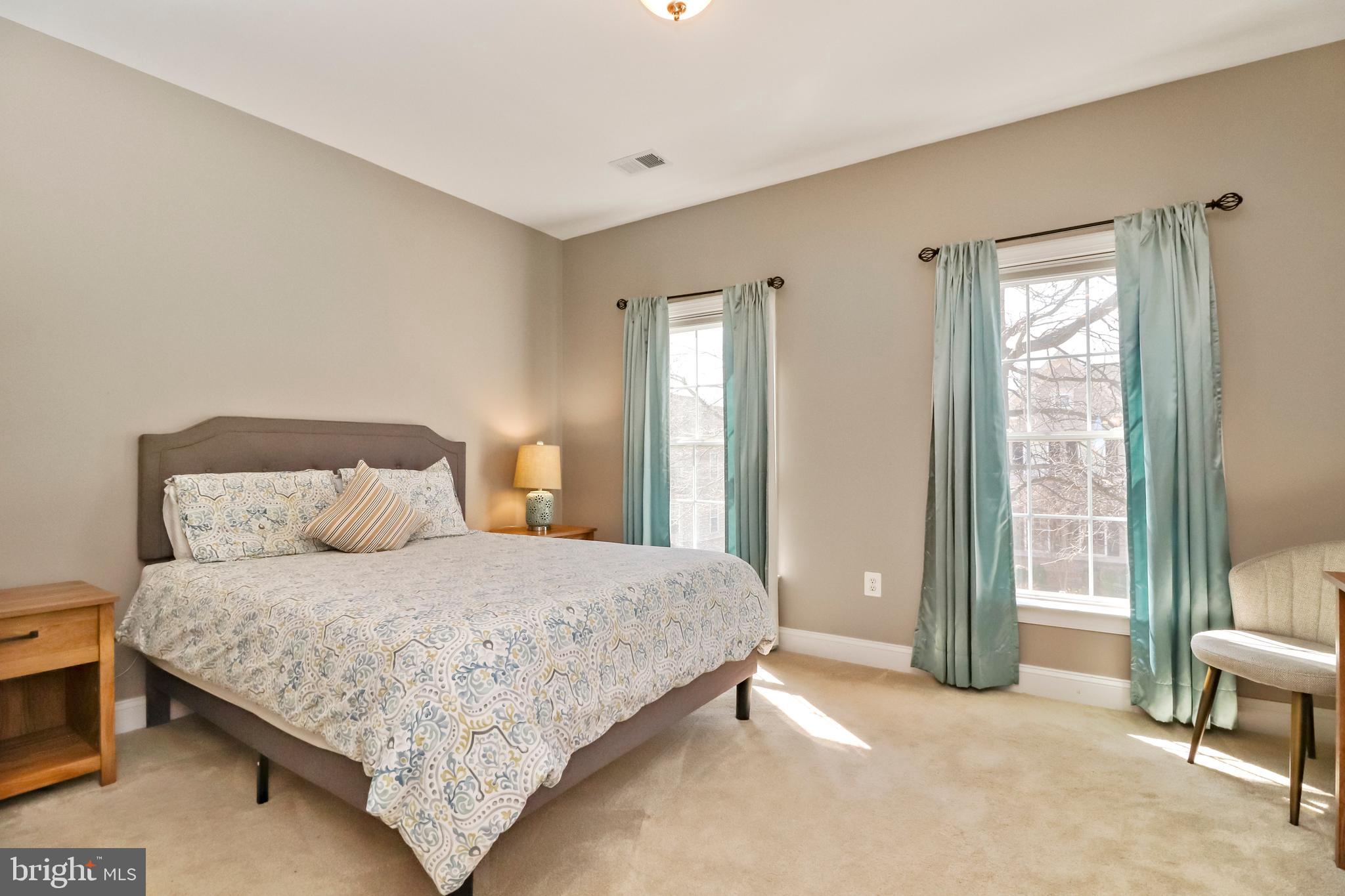 22773 Highcrest Circle Brambleton, VA 20148 - Photo 26 of 40 a bedroom with a bed and a lamp next to a window