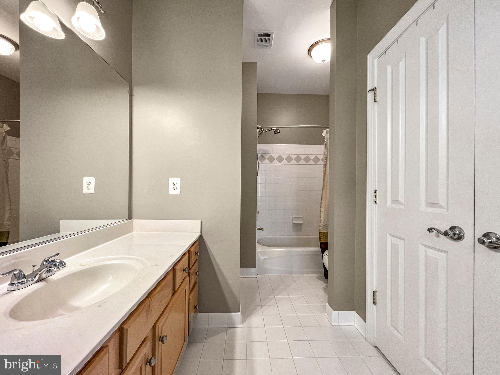 22773 Highcrest Circle Brambleton, VA 20148 - Photo 27 of 40 a spacious bathroom with a sink and a mirror