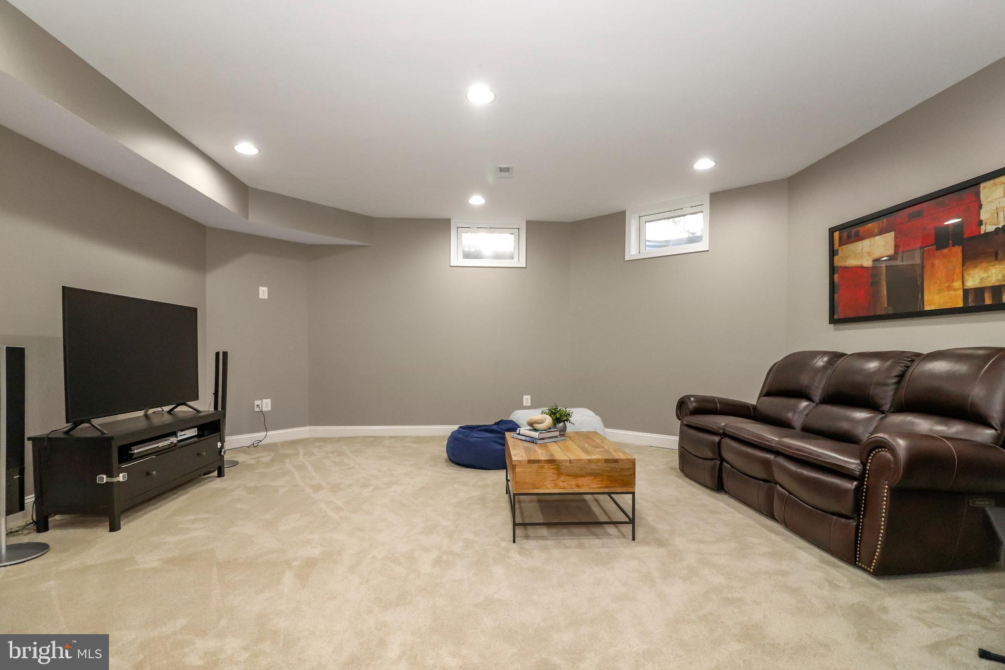 22773 Highcrest Circle Brambleton, VA 20148 - Photo 30 of 40 a living room with furniture and a flat screen tv