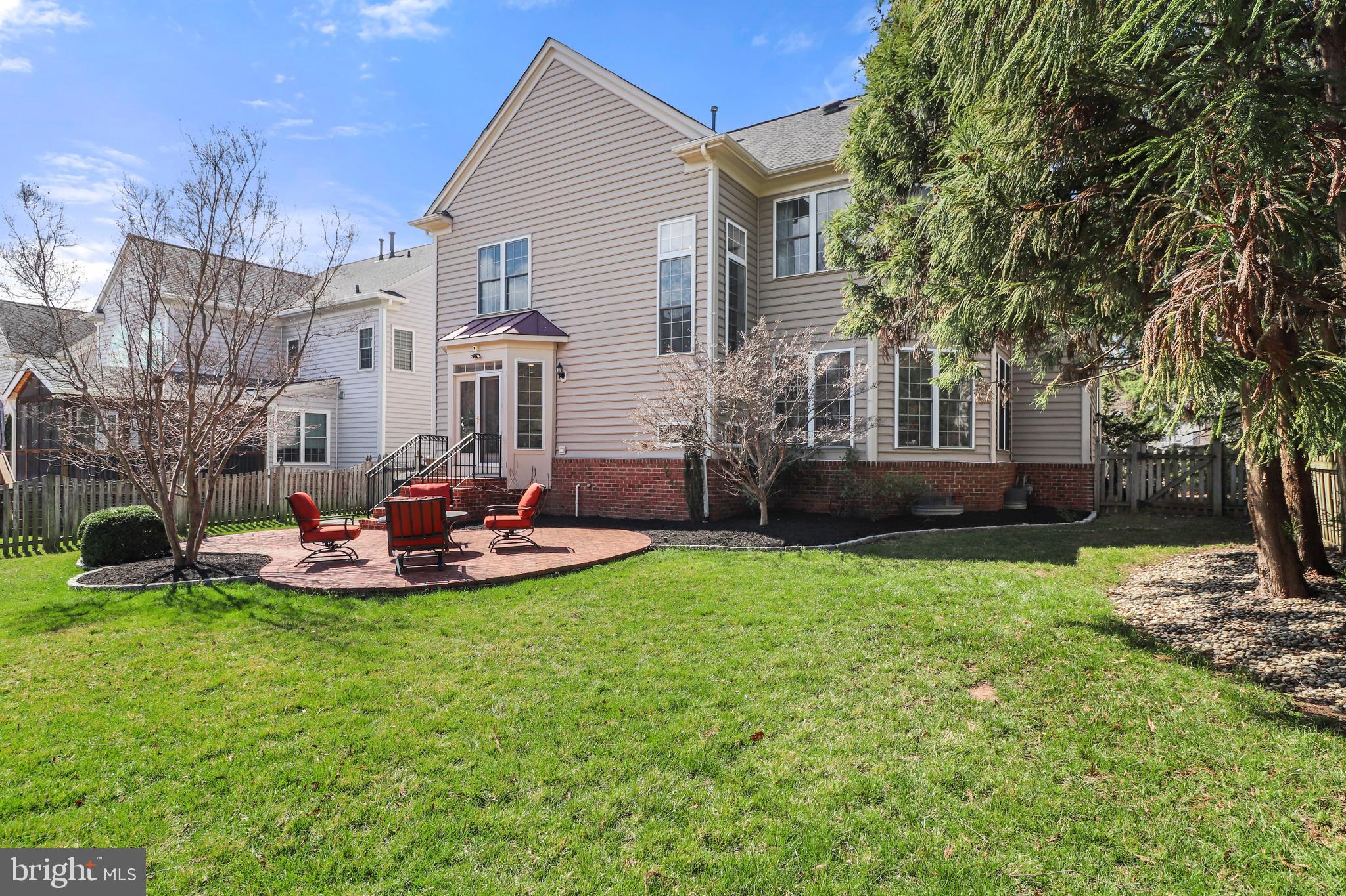22773 Highcrest Circle Brambleton, VA 20148 - Photo 35 of 40 a view of a house with a backyard and a patio
