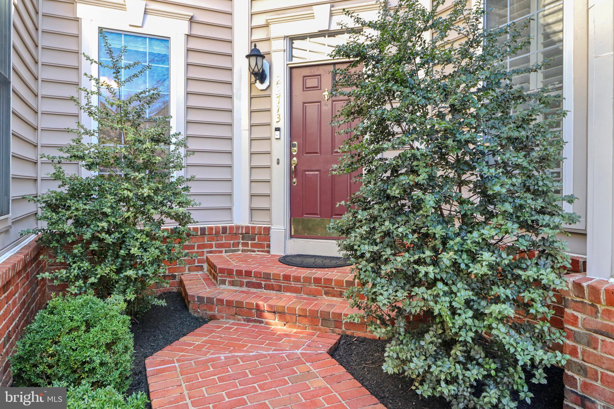 22773 Highcrest Circle Brambleton, VA 20148 - Photo 4 of 40 a pathway of a house with a yard