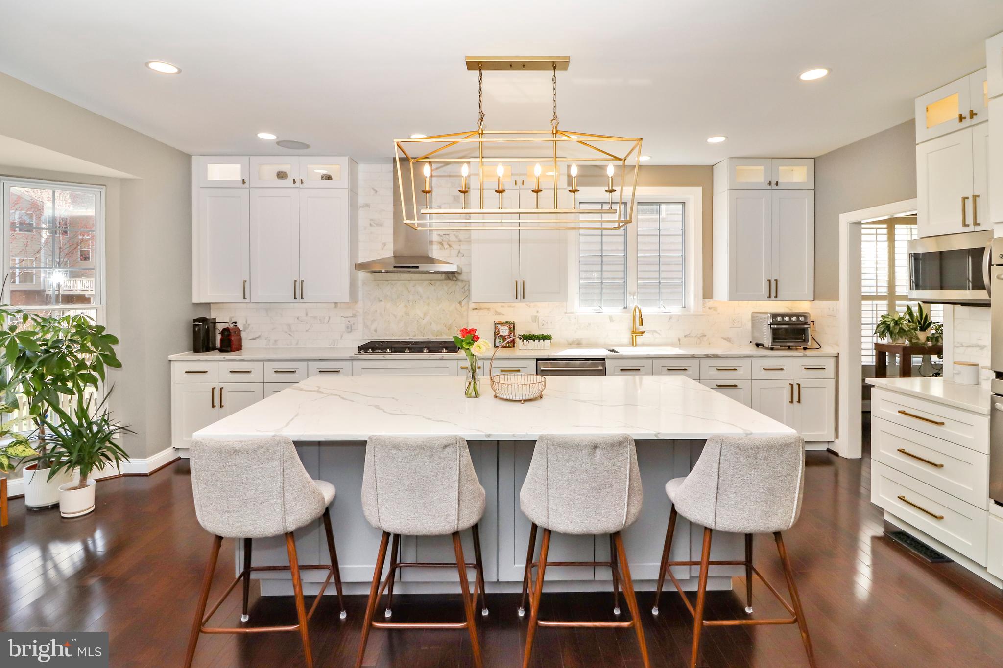 22773 Highcrest Circle Brambleton, VA 20148 - Photo 5 of 40 a kitchen with granite countertop white cabinets and stainless steel appliances
