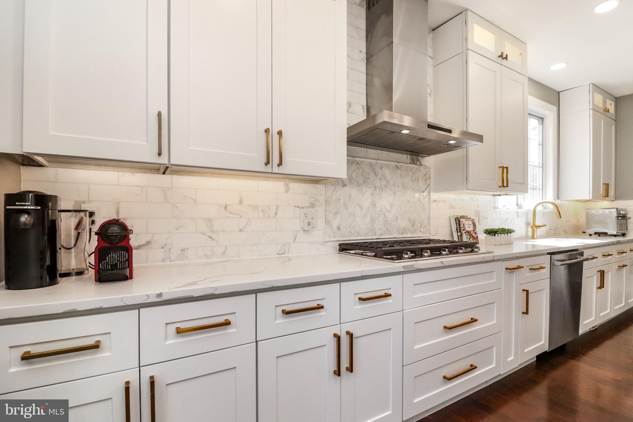 22773 Highcrest Circle Brambleton, VA 20148 - Photo 6 of 40 a kitchen with stainless steel appliances white cabinets and a stove