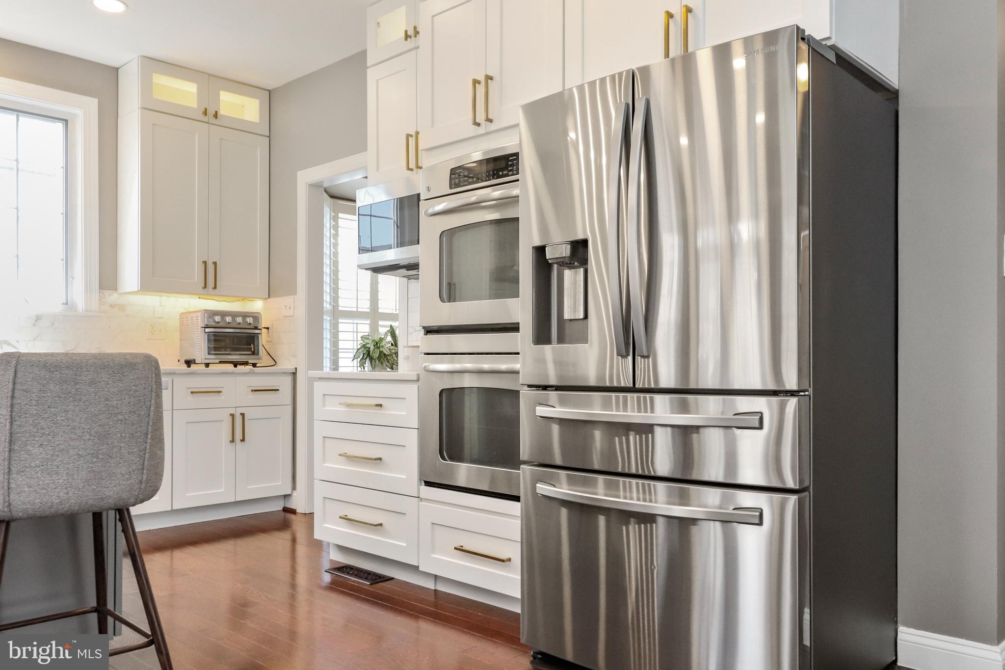 22773 Highcrest Circle Brambleton, VA 20148 - Photo 9 of 40 a kitchen with stainless steel appliances a refrigerator stove and microwave