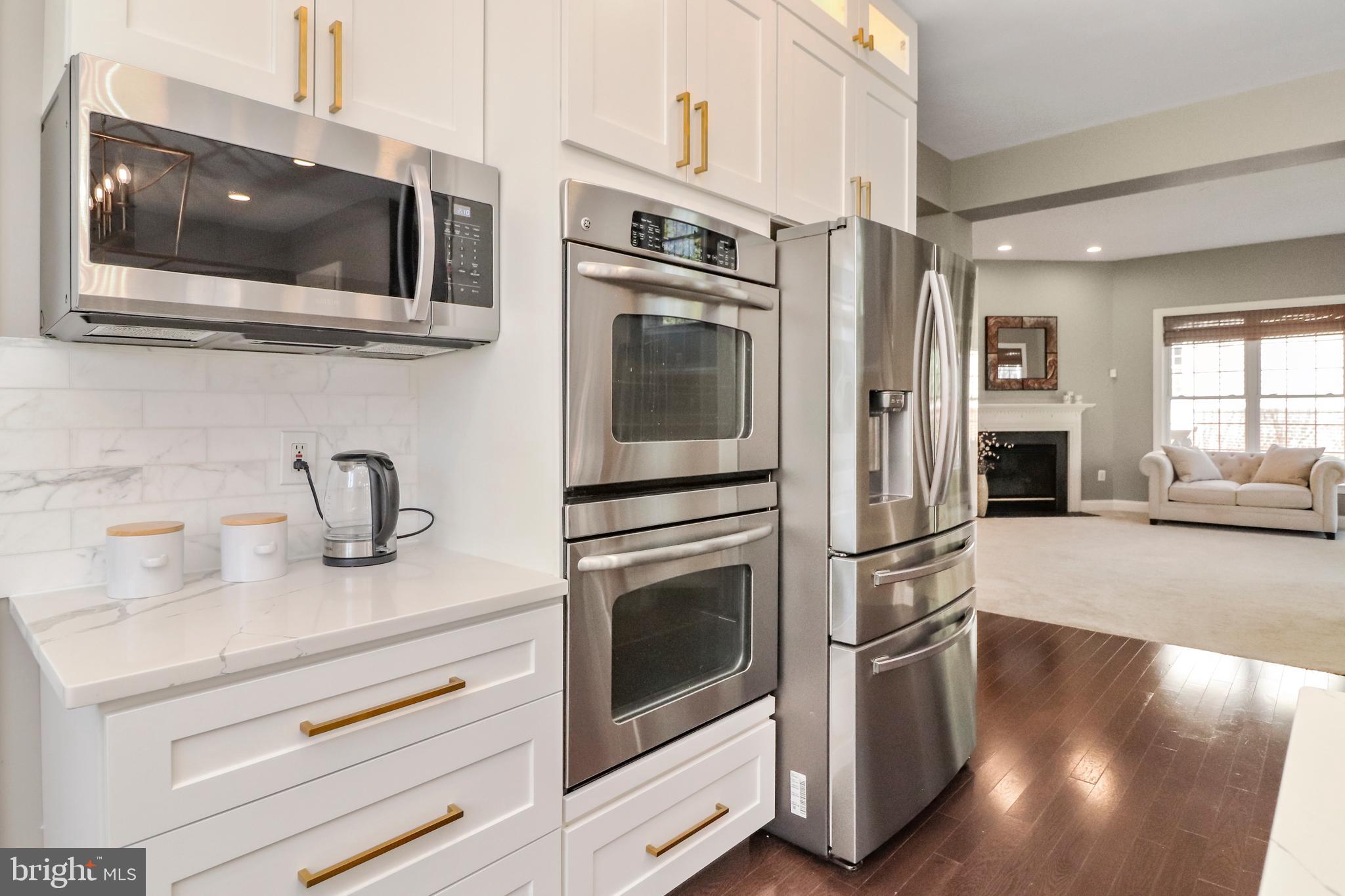 22773 Highcrest Circle Brambleton, VA 20148 - Photo 10 of 40 a kitchen with stainless steel appliances granite countertop a refrigerator and a stove top oven