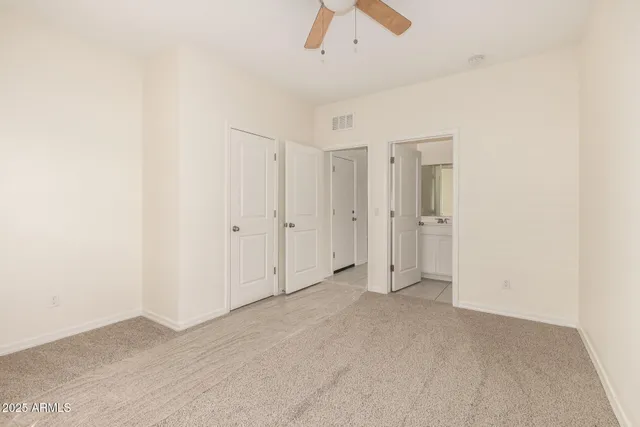 an empty room with chandelier fan