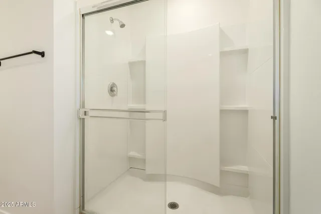 a bathroom with a glass shower door