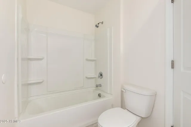 a white bath tub sitting next to a white toilet