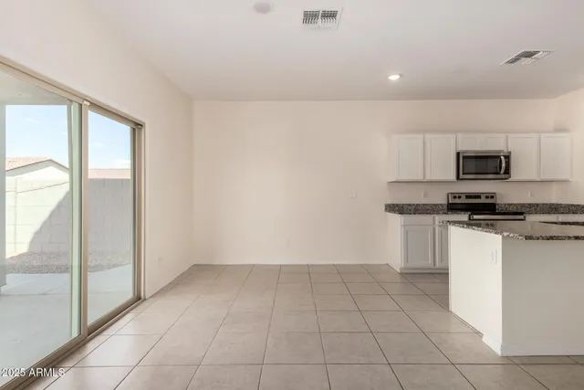 a view of kitchen with microwave and cabinets