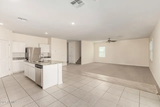 a kitchen with stainless steel appliances granite countertop a sink and cabinets