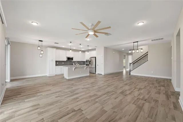 a view of kitchen with wooden floor and windows