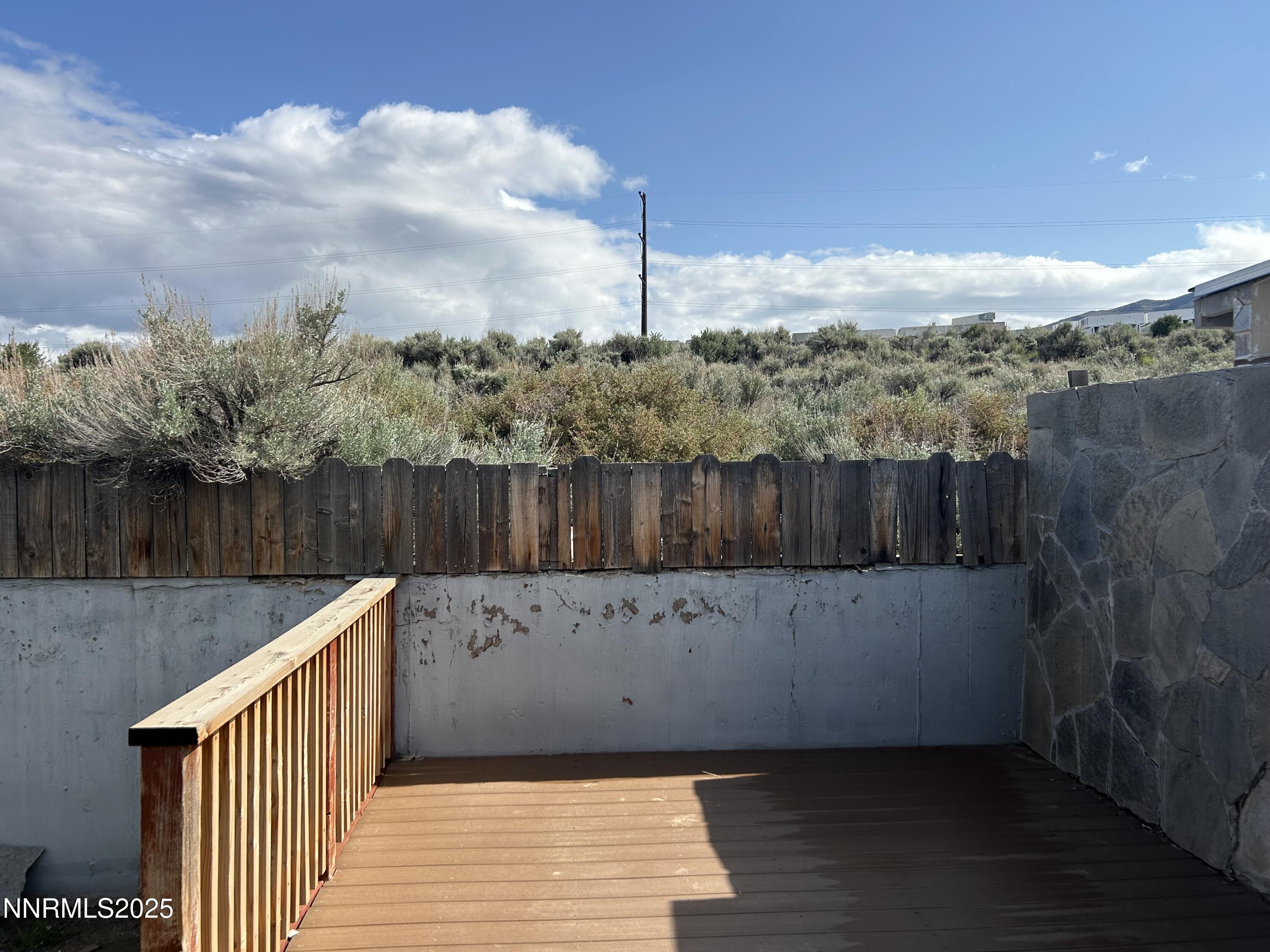 6780 Peppermint Drive Reno, NV 89506 - Photo 15 of 16 a view of a terrace with a wooden fence and floor