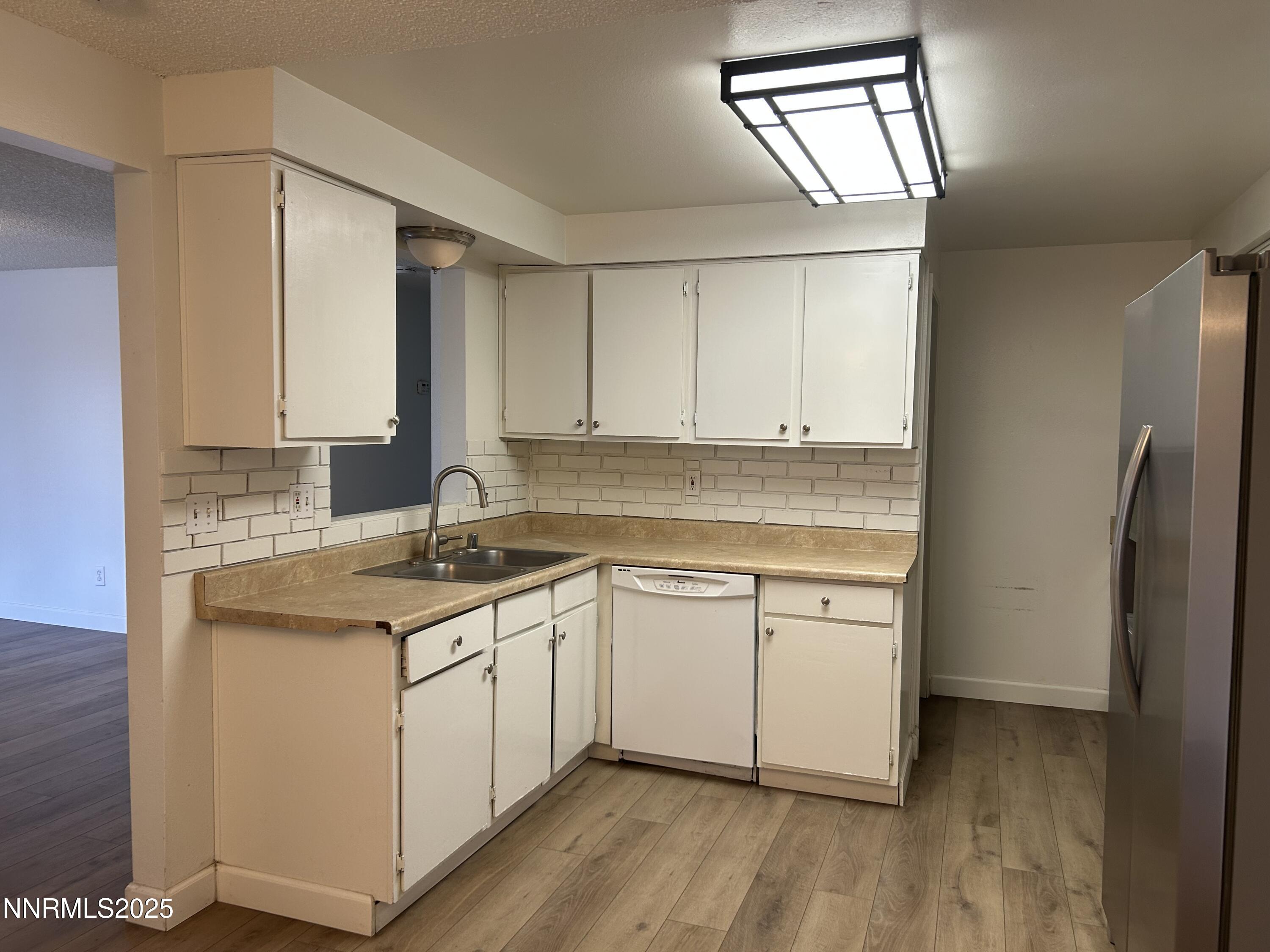 6780 Peppermint Drive Reno, NV 89506 - Photo 2 of 16 a kitchen with a sink cabinets stainless steel appliances and a window