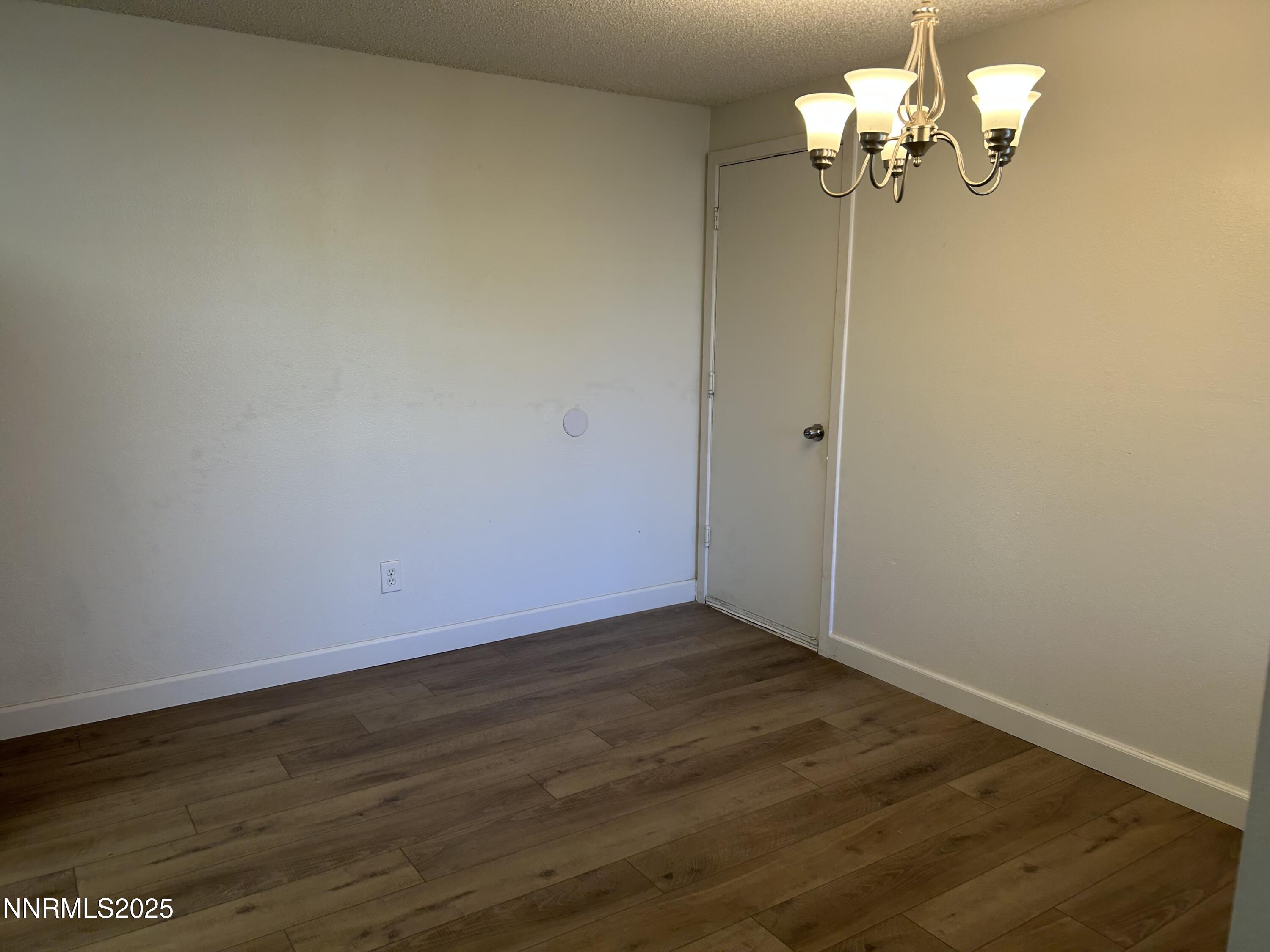 6780 Peppermint Drive Reno, NV 89506 - Photo 5 of 16 a view of a room with wooden floor and ceiling fan
