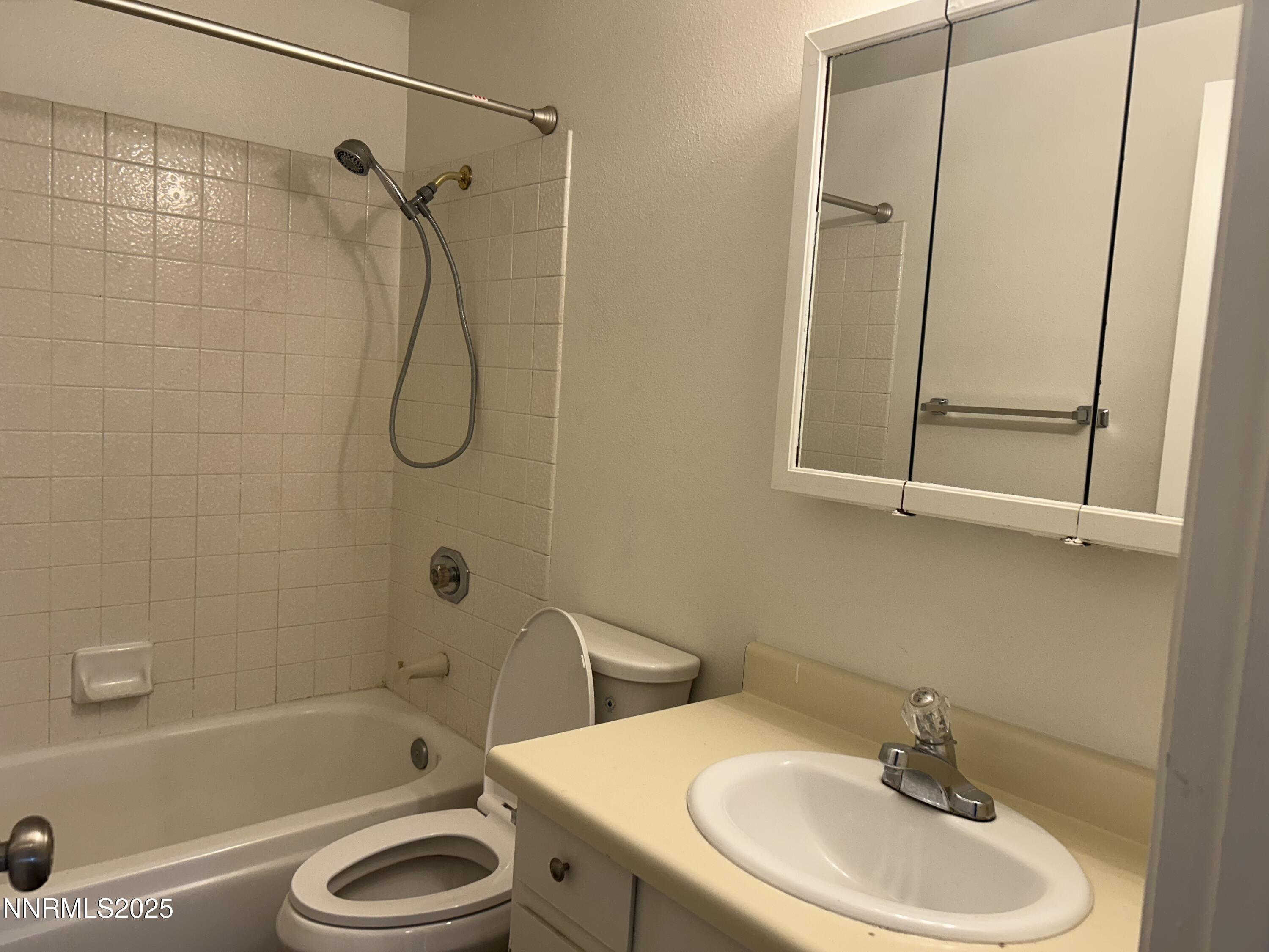 6780 Peppermint Drive Reno, NV 89506 - Photo 9 of 16 a bathroom with a sink a mirror and a bathtub