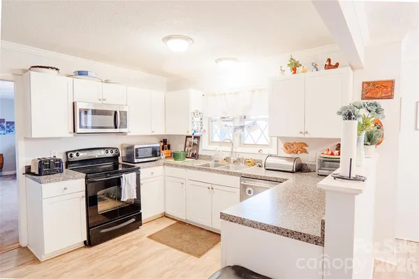 a kitchen with a sink cabinets and window
