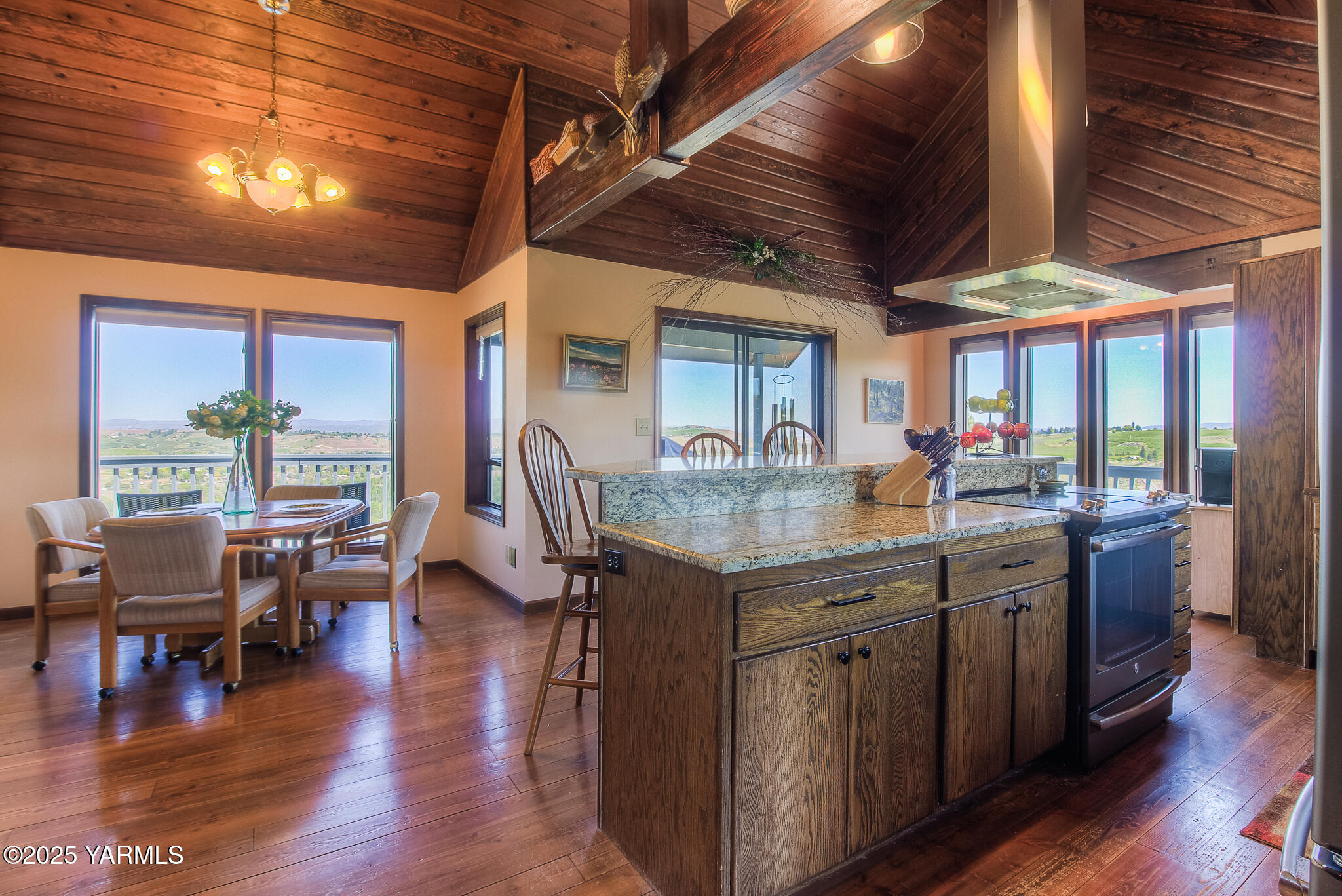541 Basalt Springs Way Yakima, WA 98908 - Photo 11 of 51 a kitchen with stainless steel appliances granite countertop a table chairs and wooden floors