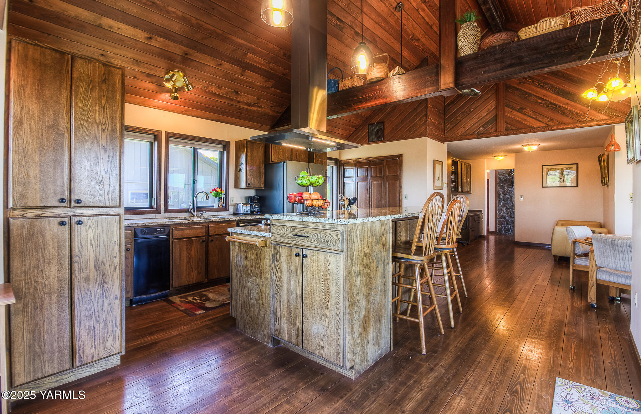 541 Basalt Springs Way Yakima, WA 98908 - Photo 18 of 51 a kitchen with stainless steel appliances granite countertop a table chairs and wooden floor