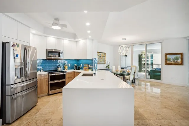 a kitchen with counter top space a refrigerator and furniture