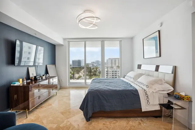 a spacious bedroom with a bed couch and a window