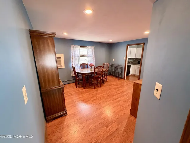 a living room with furniture and a refrigerator