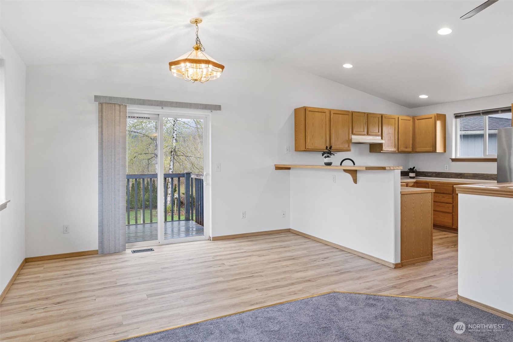 219 Nugget Road Gold Bar, WA 98251 - Photo 8 of 39 a view of a kitchen with a stove wooden cabinets and a window