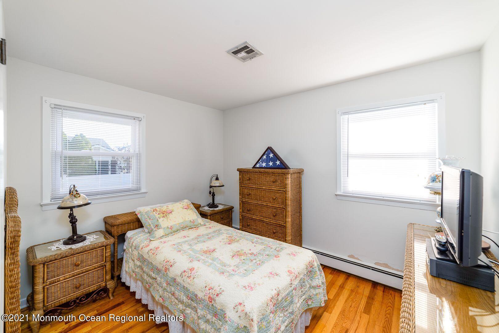 125 Jordan Road Brick, NJ 08724 - Photo 9 of 28 a bedroom with a bed and wooden floor