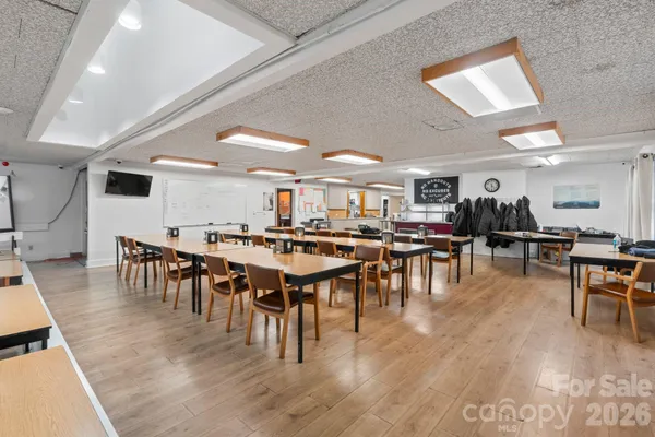 a room with lots of furniture and white appliances