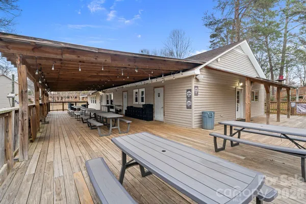 a view of a chairs and table on the deck with wooden floor and fence