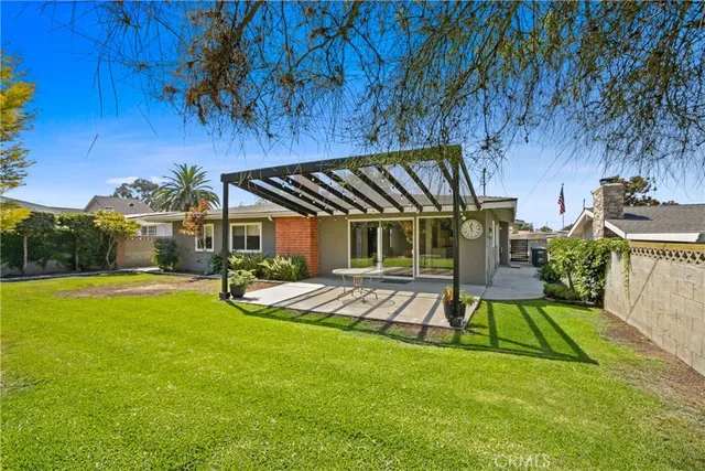 a view of a backyard with table and chairs with wooden floor and fence
