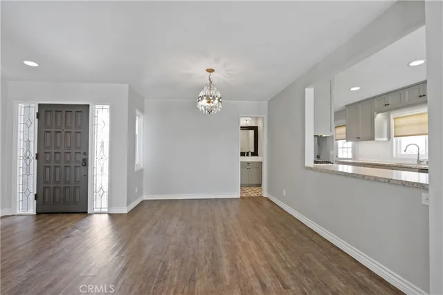 a view of a kitchen with wooden floor and a kitchen