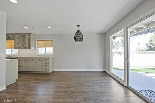 a room with a window and a kitchen view