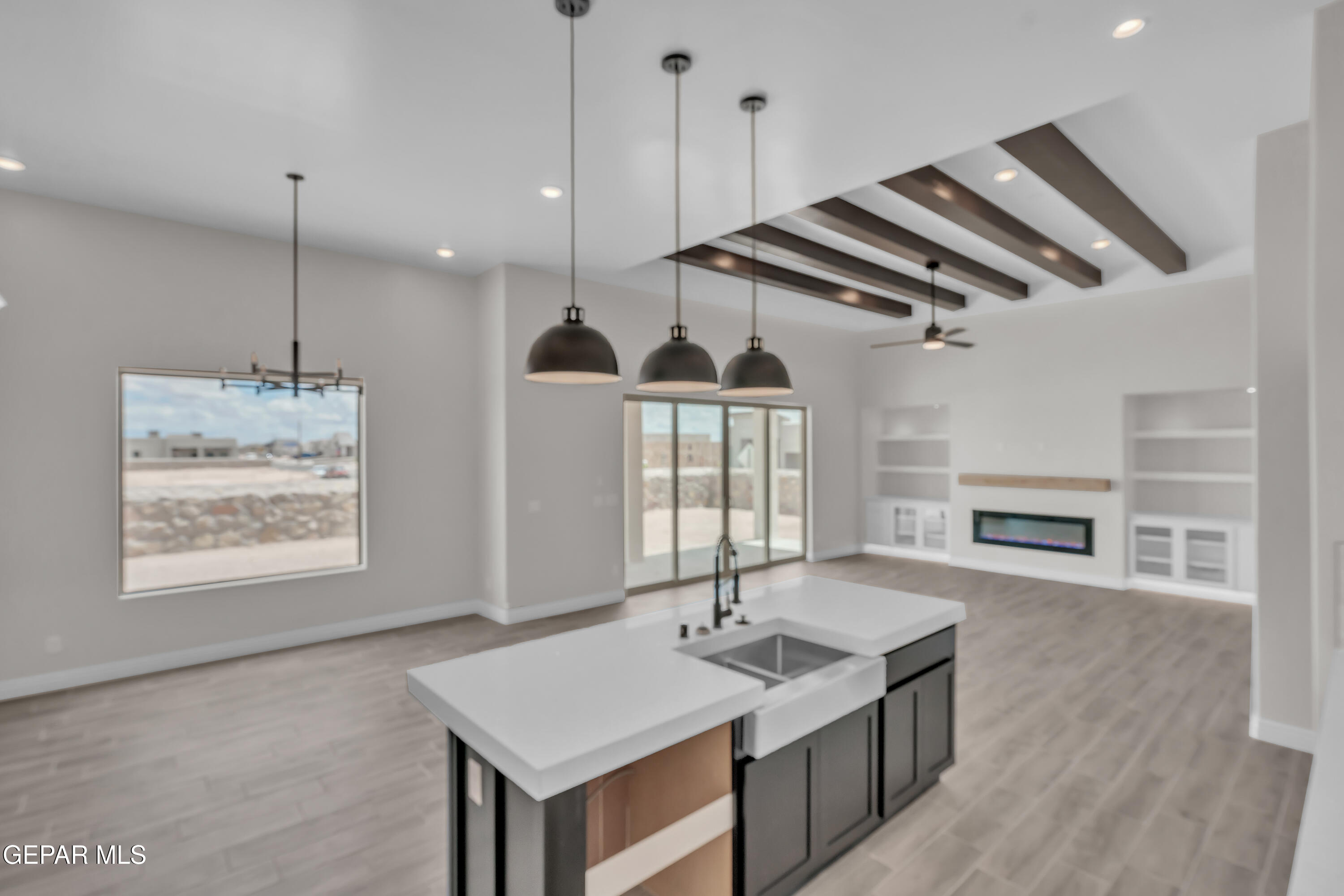 1849 War Path El Paso, TX 79911 - Photo 13 of 18 a kitchen with stainless steel appliances granite countertop a stove a refrigerator and a wooden floor