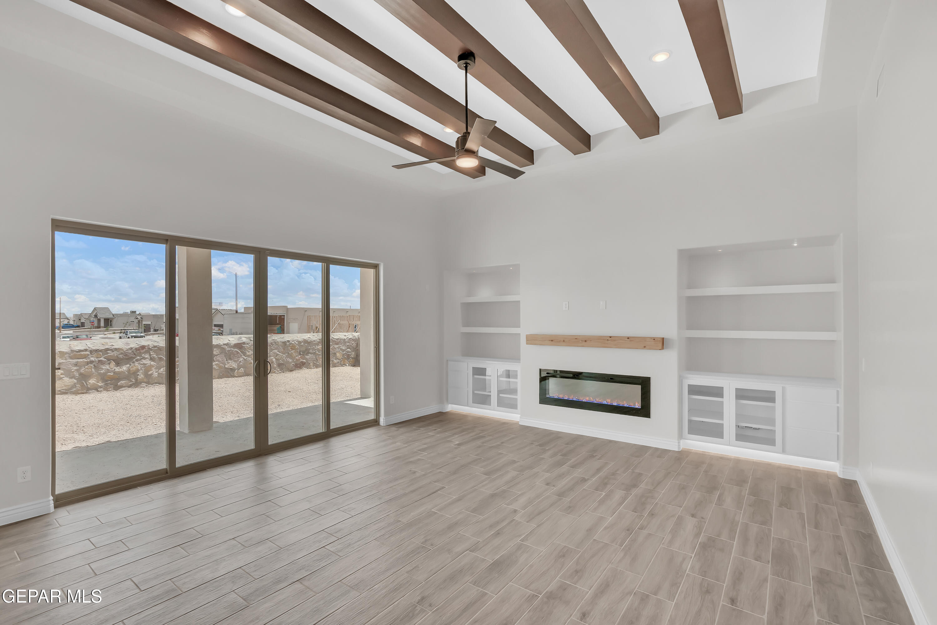 1849 War Path El Paso, TX 79911 - Photo 7 of 18 wooden floor in an empty room with a fireplace