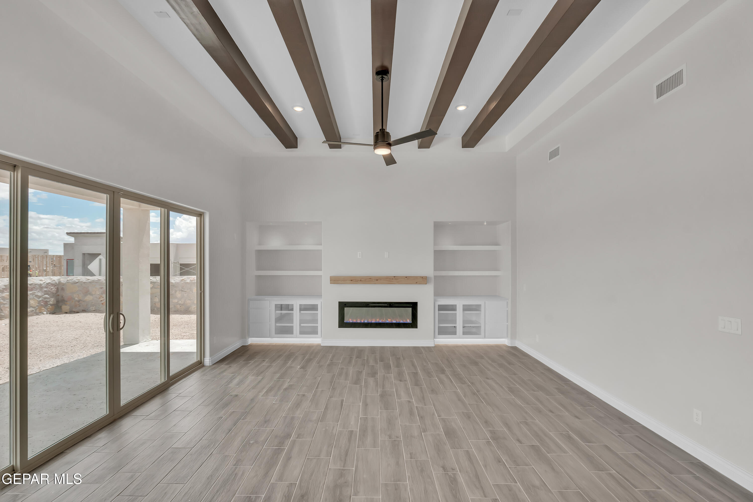 1849 War Path El Paso, TX 79911 - Photo 9 of 18 wooden floor in an empty room with a fireplace