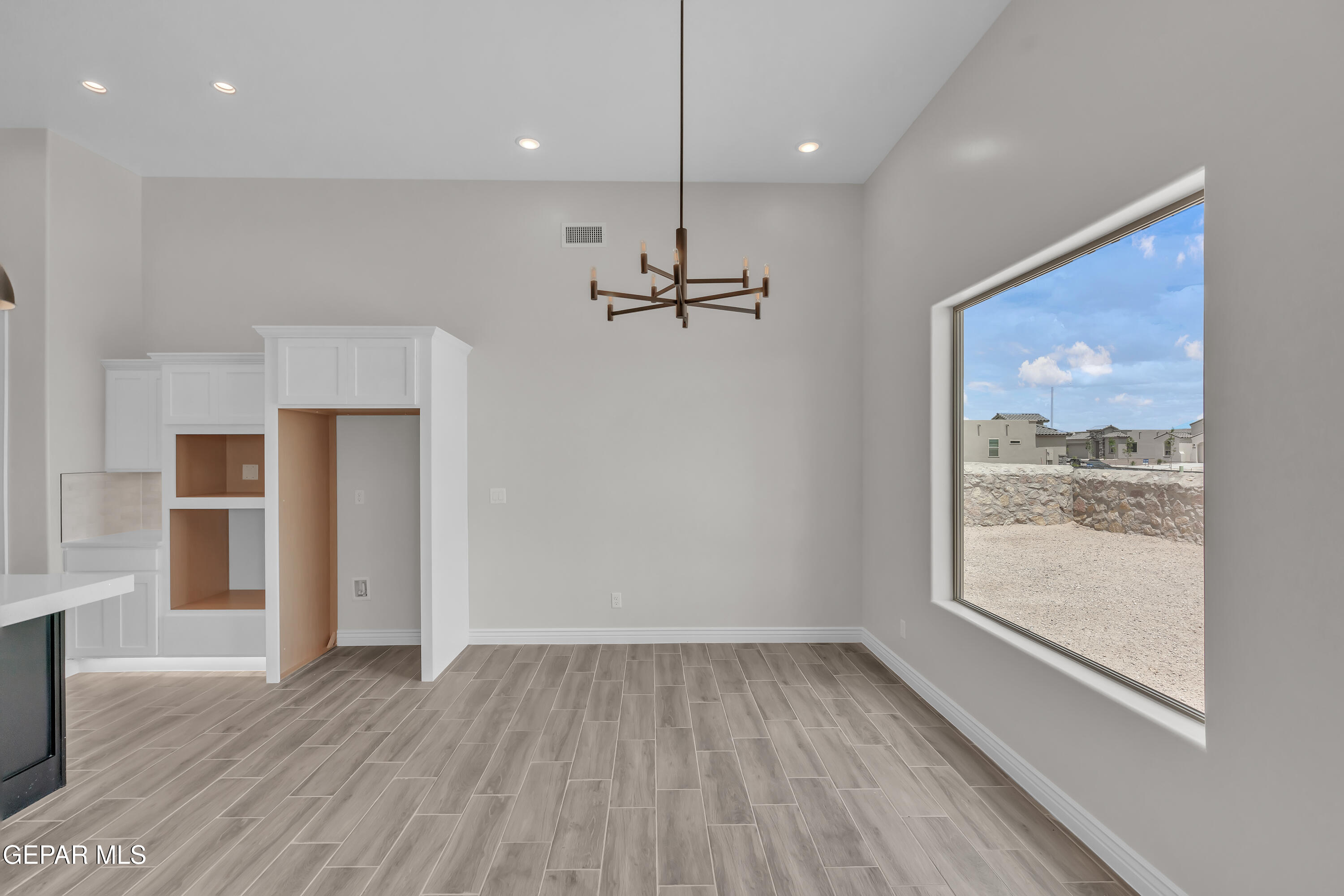 1849 War Path El Paso, TX 79911 - Photo 10 of 18 an empty room with wooden floor a ceiling fan and windows