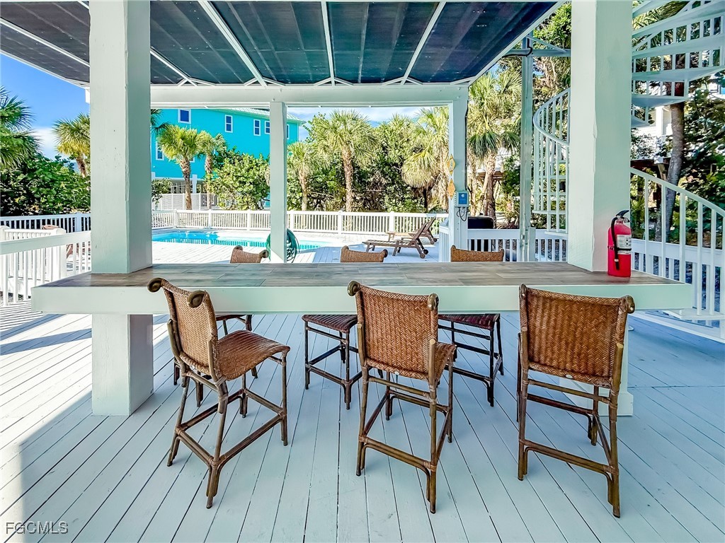 4560 Conch Shell Drive Upper Captiva, FL 33924 - Photo 12 of 50 a dining room with furniture and wooden floor