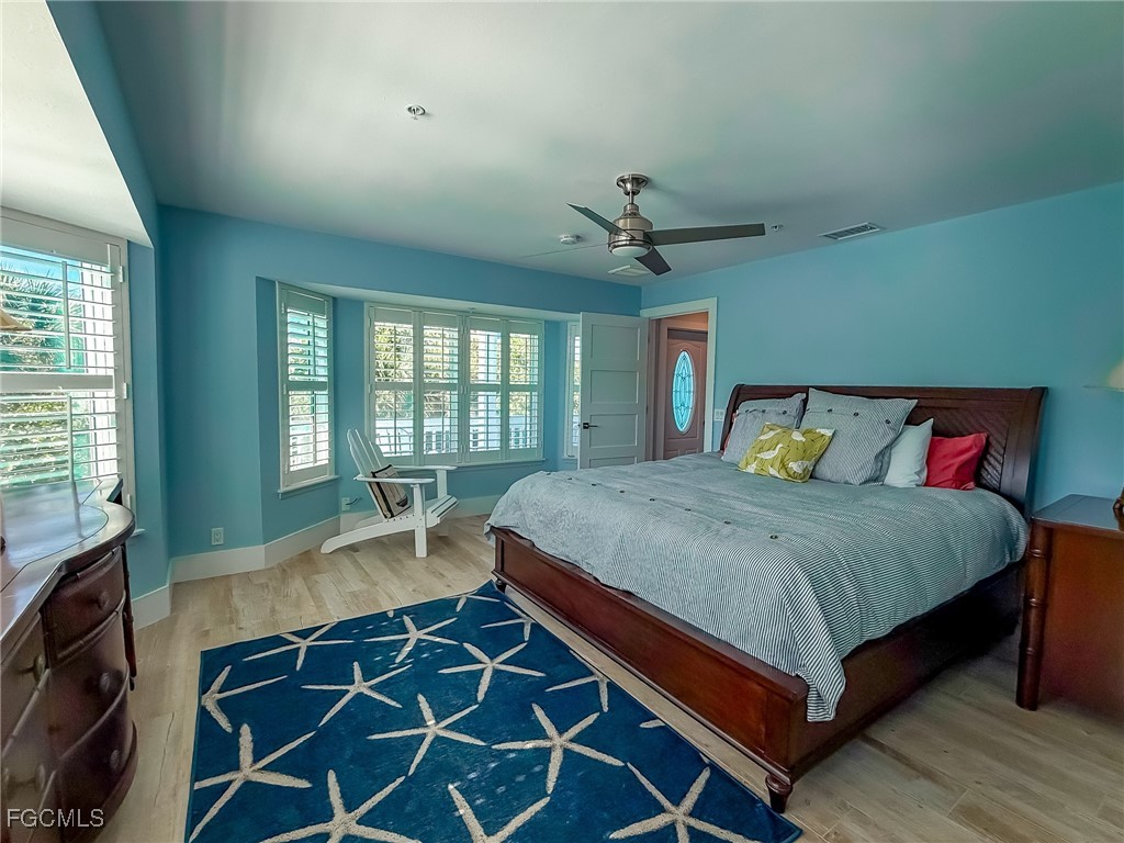 4560 Conch Shell Drive Upper Captiva, FL 33924 - Photo 18 of 50 a bed sitting in a bedroom next to a window