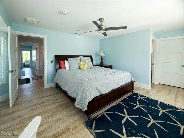 a bedroom with a bed and painting on the wall