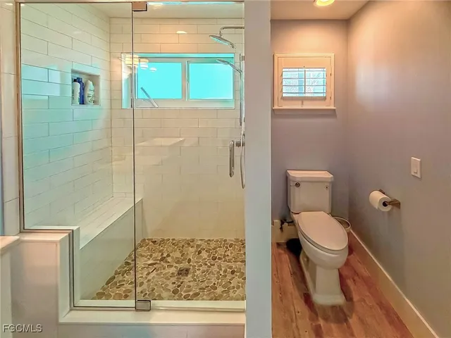 a bathroom with a toilet and a shower