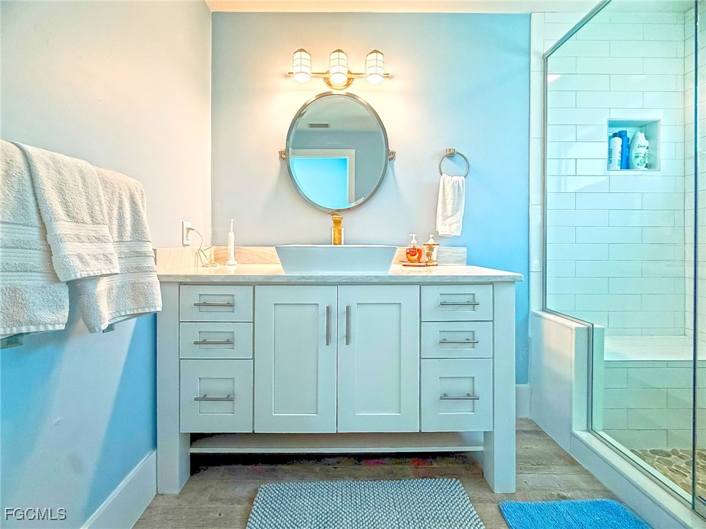 4560 Conch Shell Drive Upper Captiva, FL 33924 - Photo 23 of 50 a bathroom with a sink and a mirror